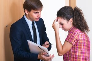 angry man collector and scared girl standing doorway