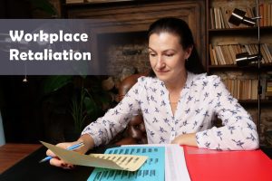 business concept about workplace retaliation female office workers with yellow shirt holding and writing documents on office desk